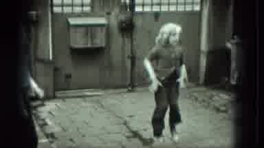 West Germany (1951): A Young Girl Jumping Rope As Her Caped Friend Turns The Rope
