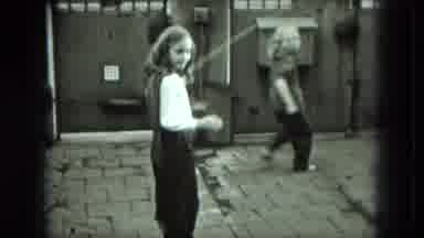 West Germany (1951): Two Girls Playing In Brick Yard With Skipping Rope In Day