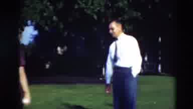 Paducah Kentucky USA (1951): People Walking On Green Grass On A Bright Sunny Day