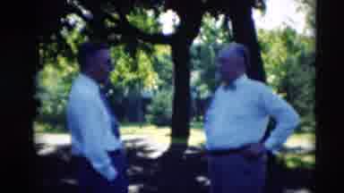 Paducah Kentucky USA-1951: Well Dressed Men And Women Gather Outside Together On