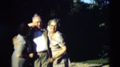 Paducah Kentucky USA (1951): Men And Women Hug As Others Stand Back And Talk To