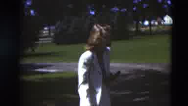 Paducah Kentucky USA (1951): Woman Plays With Friends Outside The House On A Nice