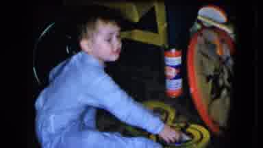 Cleveland Ohio (1951): Young Boy Sitting On A Carpeted Floor Happily Playing With