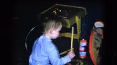 Cleveland Ohio (1951): Young Boy In Pajamas Seated On Floor Hitting Drum With