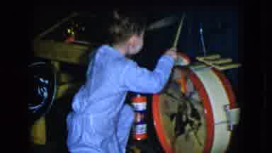 Cleveland Ohio (1951): A Young Child In A Blue Outfit Playing Some Red Drums