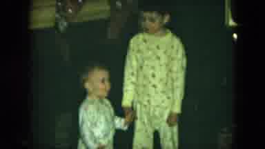 Cleveland Ohio (1951): Brother Helps Baby Brother Stand Up As He Talks To The