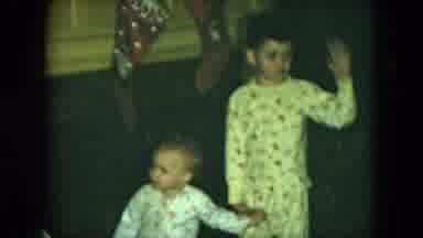 Cleveland Ohio (1951): Children Wearing White Pajamas Stand In Front Of Fireplace
