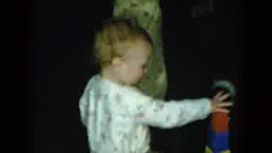 Cleveland Ohio (1951): A Baby And Boy In Pajamas Play With Blocks And Other Toys