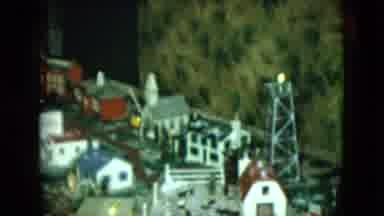 Cleveland Ohio (1951): Toy Train Passing By A Model City With Blinking Red Light