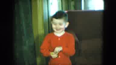 Cleveland Ohio (1951): Boy In Red Pajamas Holding Something Standing Near Chair