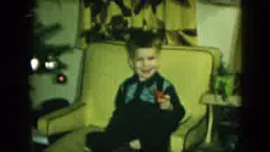 Cleveland Ohio (1951): Boy Sits In Yellow Chair Holding Red Toy Plane