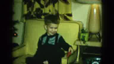 Cleveland Ohio-1951: Boy Sits In Yellow Chair Holding Red Toy Plane