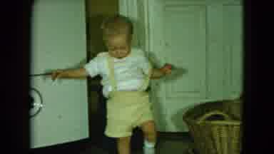 Cleveland Ohio (1951): Toddler Learning To Walk Followed By A Group Of Children