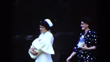 Cleveland Ohio (1951): A Nurse Hold One Child And Near The Parents Have Feeding