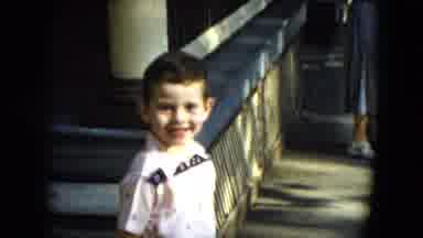 Cleveland Ohio (1951): Boy Wearing Blue And White Shirt Stands By Yellow Ramp
