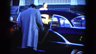 Cleveland Ohio (1951): An Elegant Man Checking His New Car While Pedestrians