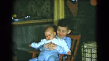 Cleveland Ohio (1951): Happy Young Boy Sitting In A Wooden Chair Sweetly Holding A