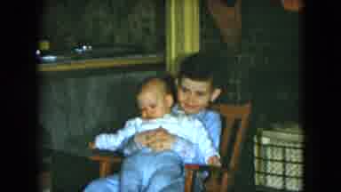 Cleveland Ohio (1951): Little Boy Proudly Sitting In A Chair Holding A Small