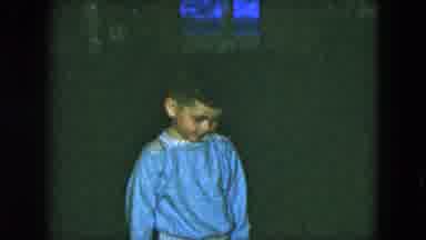 Cleveland Ohio (1951): Boy Wearing Blue Shirt Hold Looks Down At Ground While