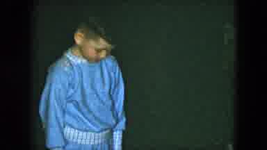 Cleveland Ohio (1951): Young Boy Crouching Outdoors In His Pajamas Looking At