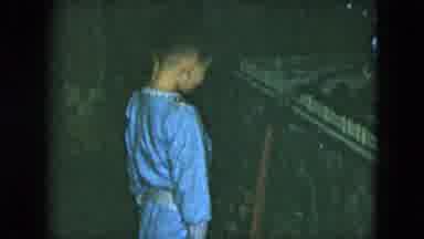 Cleveland Ohio (1951): Young Boy Wearing Blue Pajamas Investigates Presents Under
