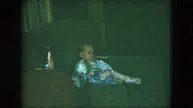 CLEVELAND OHIO-1951: Little Boy Plays With Train Set And Baby Watches