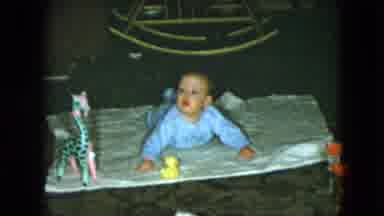 Cleveland Ohio (1951): Baby In Blue Lifting Head On Stomach Laying On Blanket