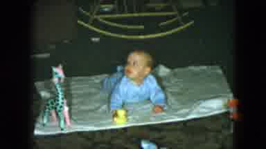 Cleveland Ohio (1951): A Small Baby Having Some Tummy Time On A Blanket Covered