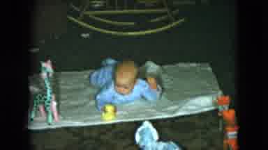 Cleveland Ohio-1951: Cute Baby Playing On White Blanket And Looking At His Toys