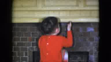 Cleveland Ohio (1951): A Young Boy Tries To Hang A Stocking On The Fireplace