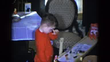 Cleveland Ohio (1951): Young Boy In Red Pajamas Deciding What Game Or Toy To Play