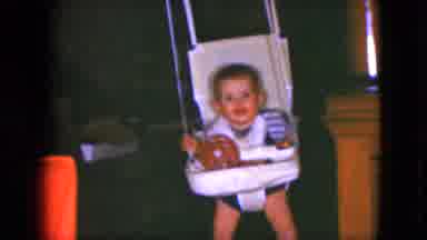 Cleveland Ohio (1951): White Baby Boy Swinging Left To Right In A Baby Tray Table