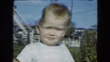 Cleveland Ohio (1951): Small Toddler Holding A Small Red Balloon While Walking In
