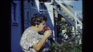 Cleveland Ohio (1951): Lady Blows Bubbles For Child In Yard On Sunny Day