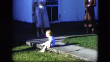 Cleveland Ohio (1951): Boy Sitting On Sidewalk On A Windy Day