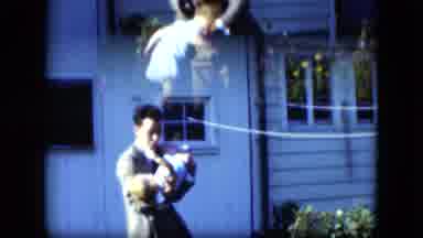 Cleveland Ohio (1951): Man Picks Up Child In Yard