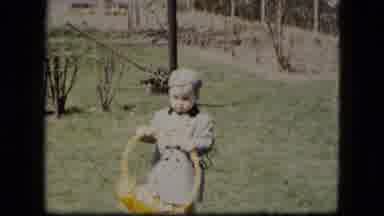 Cleveland Ohio (1951): Well-Dressed Young Boy In Garden Puts Easter Basket On The
