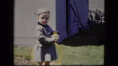 Cleveland Ohio (1951): Young Child In A Stylish Coat And Hat Holding A Toy That