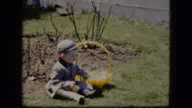 Cleveland Ohio (1951): Small Child In Grey Clothes Sitting Playing In Yard With
