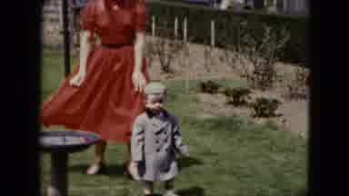 Cleveland Ohio (1951): Stylish Little Boy And Woman In A Red Dress Walking In The