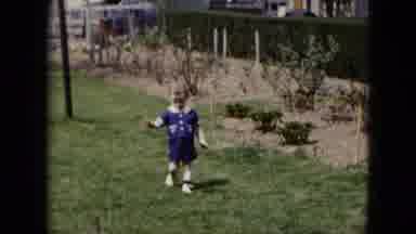 Cleveland Ohio (1951): Toddler Waving At Camera While Running In Family Yard In