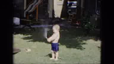 Cleveland Ohio (1951): A Little Boy Play In Garden Checking The Tube When Water