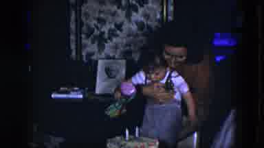 Cleveland Ohio (1951): A Woman Helping A Baby Boy Sitting Down The Chair There Is