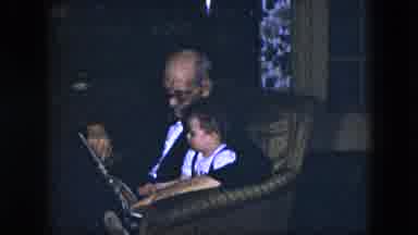 Cleveland Ohio (1951): Man Wearing Glasses Reads Book To A Small Child
