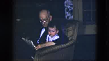 Cleveland Ohio (1951): Grandpa Sits Grandson On His Lap And Reads Him A Story At