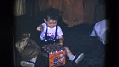 Cleveland Ohio (1951): A Child Opens Presents In Front Of Family While Having Fun