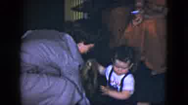 Cleveland Ohio (1951): A Woman Dressed In Vintage Attire Playing With A Boy