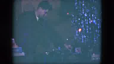 Cleveland Ohio (1951): A Man Looks At A Toy Train In Front Of A Christmas Tree