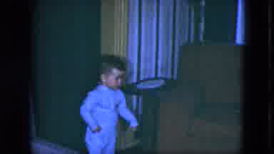 Cleveland Ohio-1951: Boy Wearing Blue Pajamas Stands Next To Brown Sofa