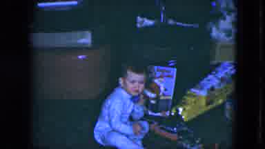 Cleveland Ohio (1951): Child Talking On A Fake Phone In Pajamas With Toys Beside